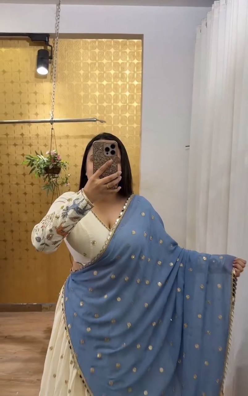 Ivory Elegance Lehenga with Pastel Blue Dupatta And Deer Motif Embroidery